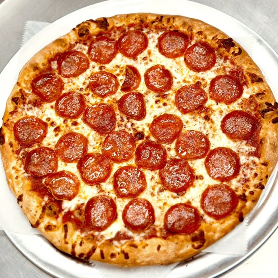 A whole pepperoni pizza from Gina's Pizzeria, with melted cheese and a golden crust.