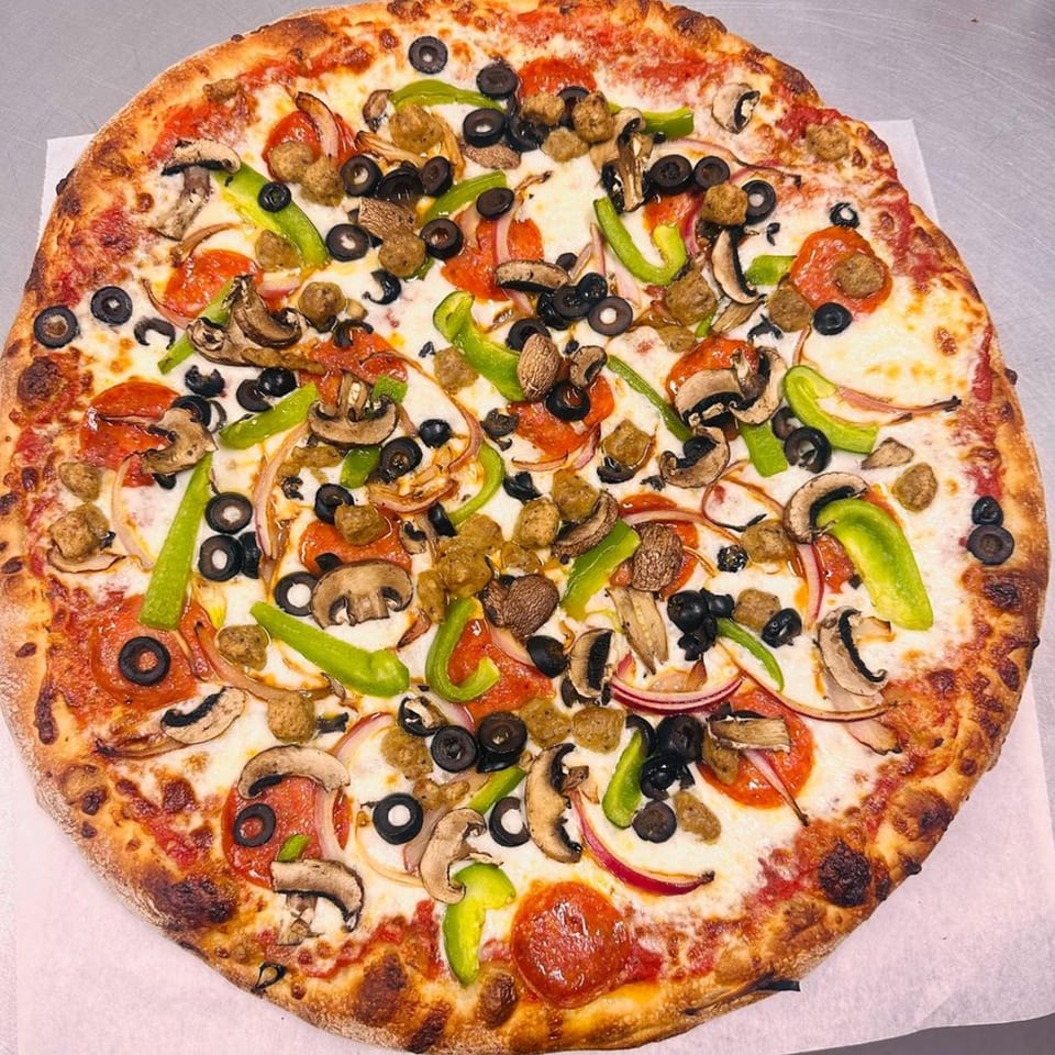 Gina's Pizzeria's large pizza with pepperoni, sausage, mushrooms, olives, green peppers, and onions.